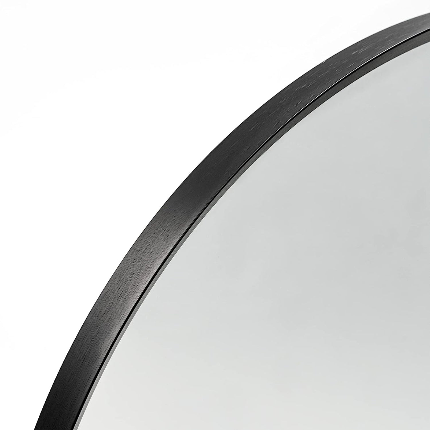 Arched black aluminum bathroom mirror with sleek frame, modern design, and reflective glass, by Anthony & Home.