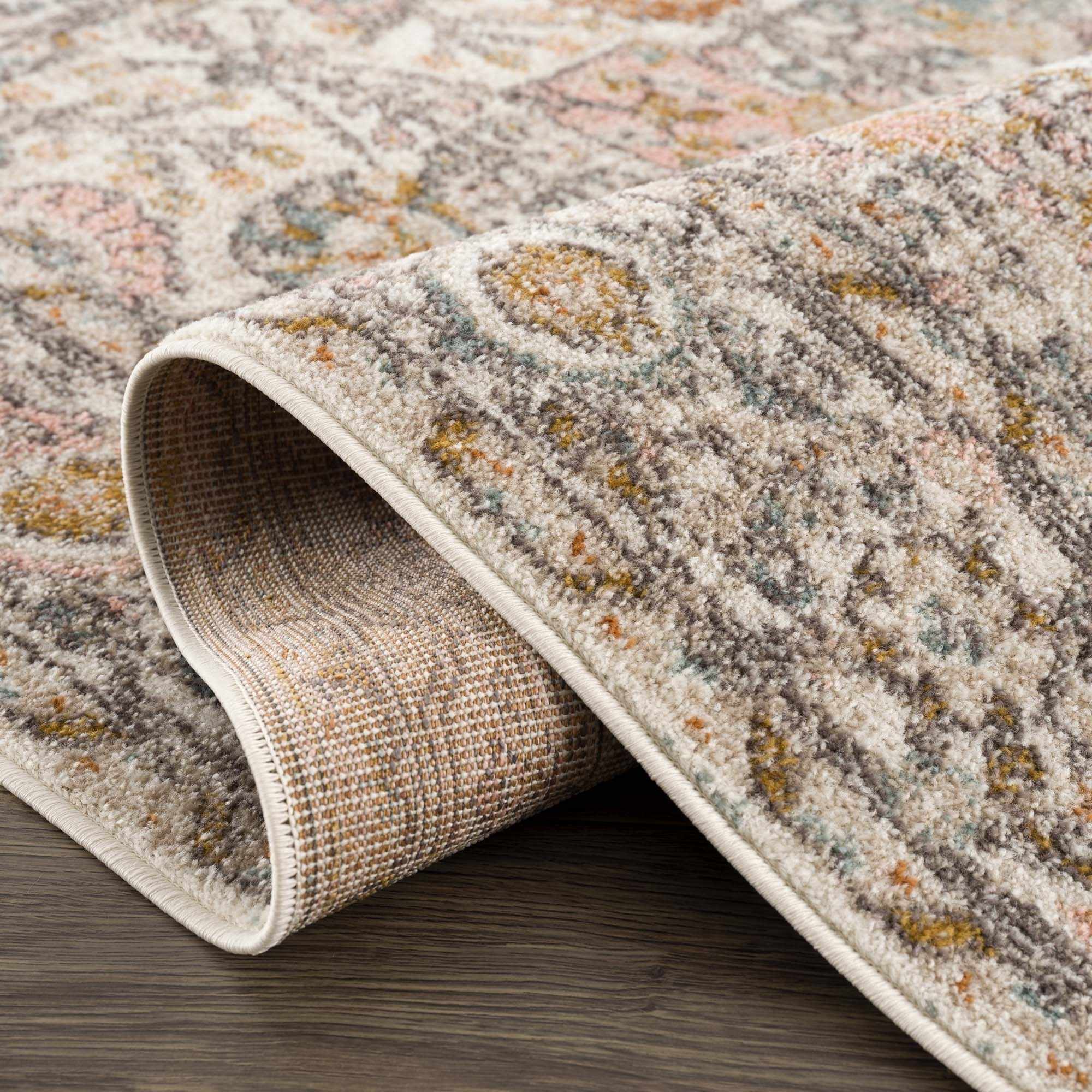 Folded Herstmonceux Area Rug by Boutique Rugs showcasing intricate patterns and soft textures in neutral tones.