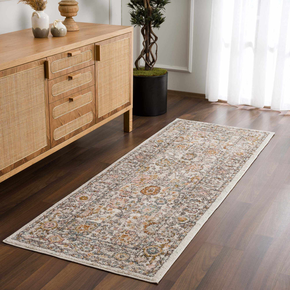Herstmonceux Area Rug by Boutique Rugs displayed in a room scene, showcasing intricate pattern and warm color tones.