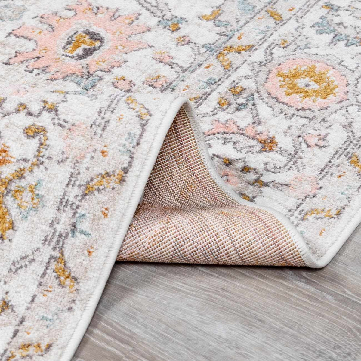 Folded Herstmonceux Area Rug by Boutique Rugs showing textured, neutral-toned fabric suitable for living room or bedroom decor.
