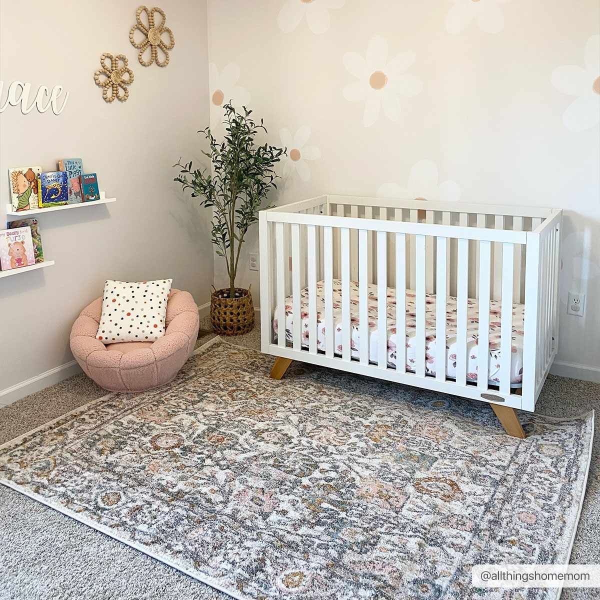 Herstmonceux area rug by Boutique Rugs featuring intricate patterns in neutral tones, displayed on a hardwood floor.
