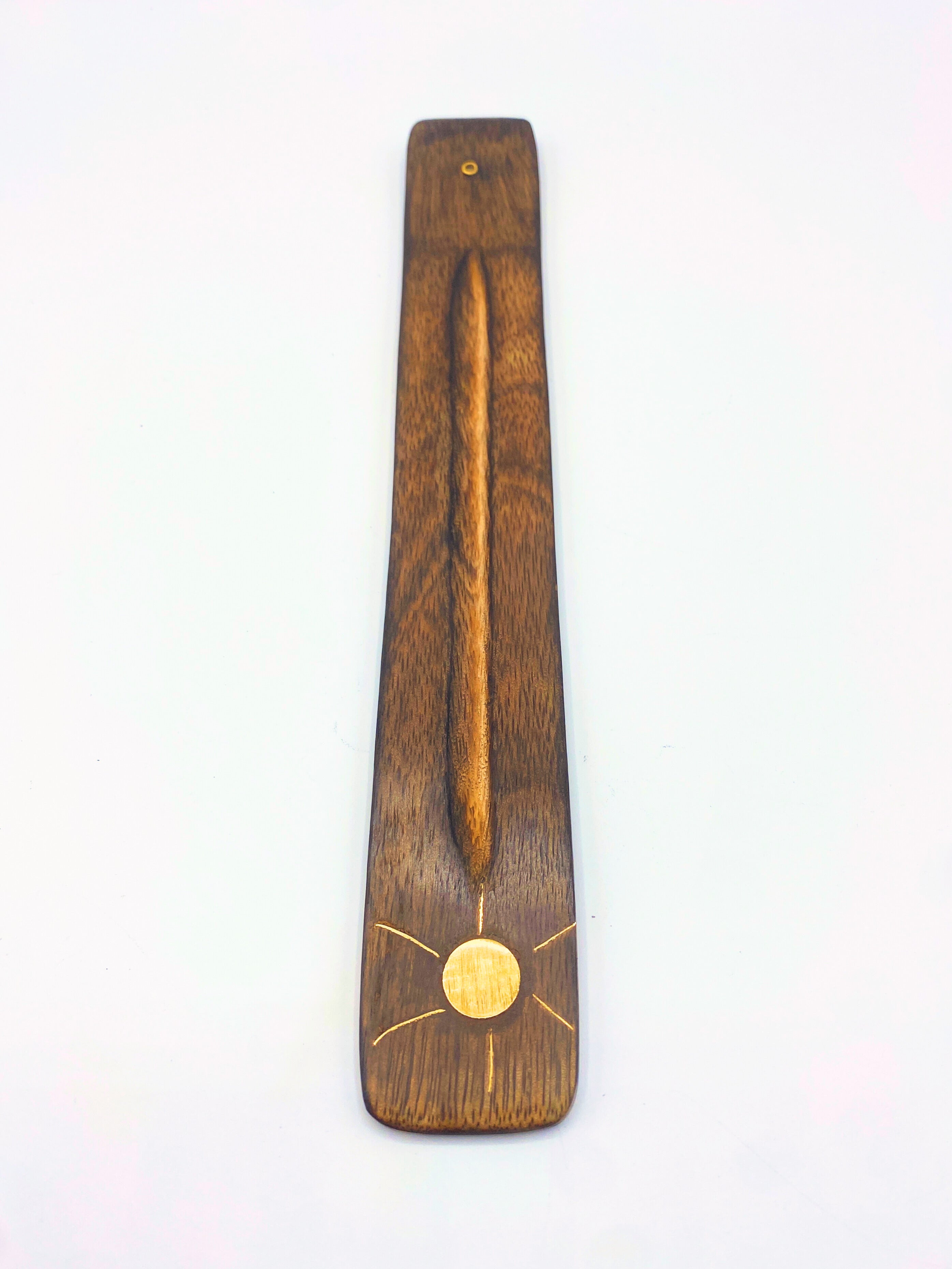 Brass incense holder with celestial sun inlay, decorative burner designed for burning incense sticks or cones.
