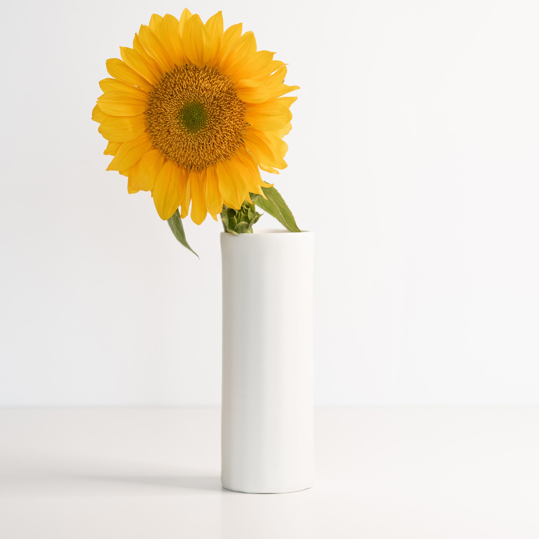 Handmade porcelain Bloom Vase by Ember Collective, showcasing a smooth, elegant flower vase with a glossy finish.