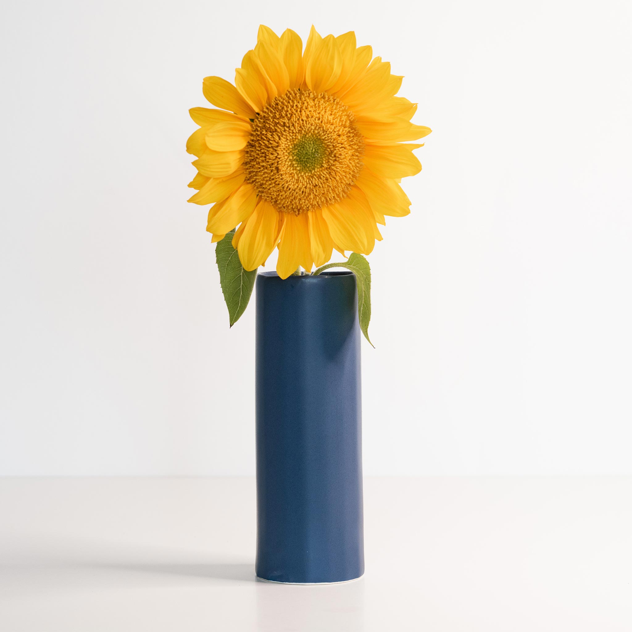 Handmade porcelain Bloom Vase by Ember Collective, showcasing a sleek, elegant flower vase with a smooth, glossy finish.