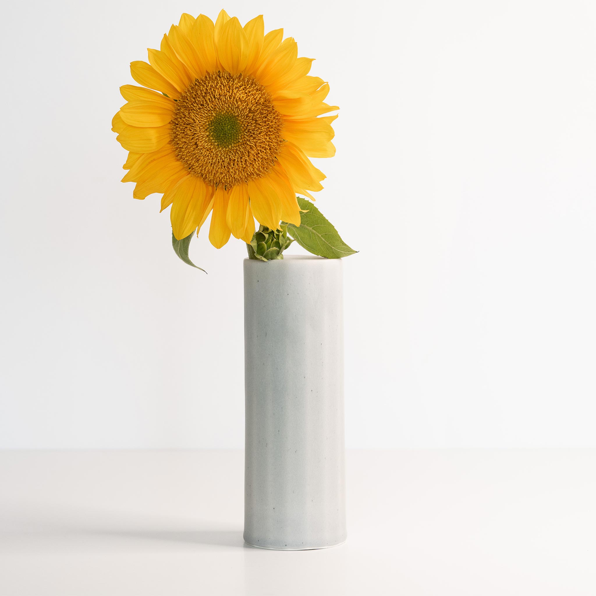 Handmade porcelain Bloom Vase by Ember Collective featuring a smooth, white finish and elegant, curved shape.