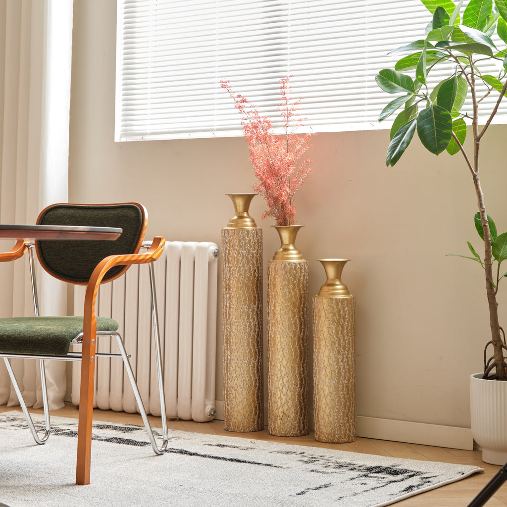 Set of three Anthony & Home Heritage Collection gold distressed metal vases with growing vine pattern, perfect for living room decor.