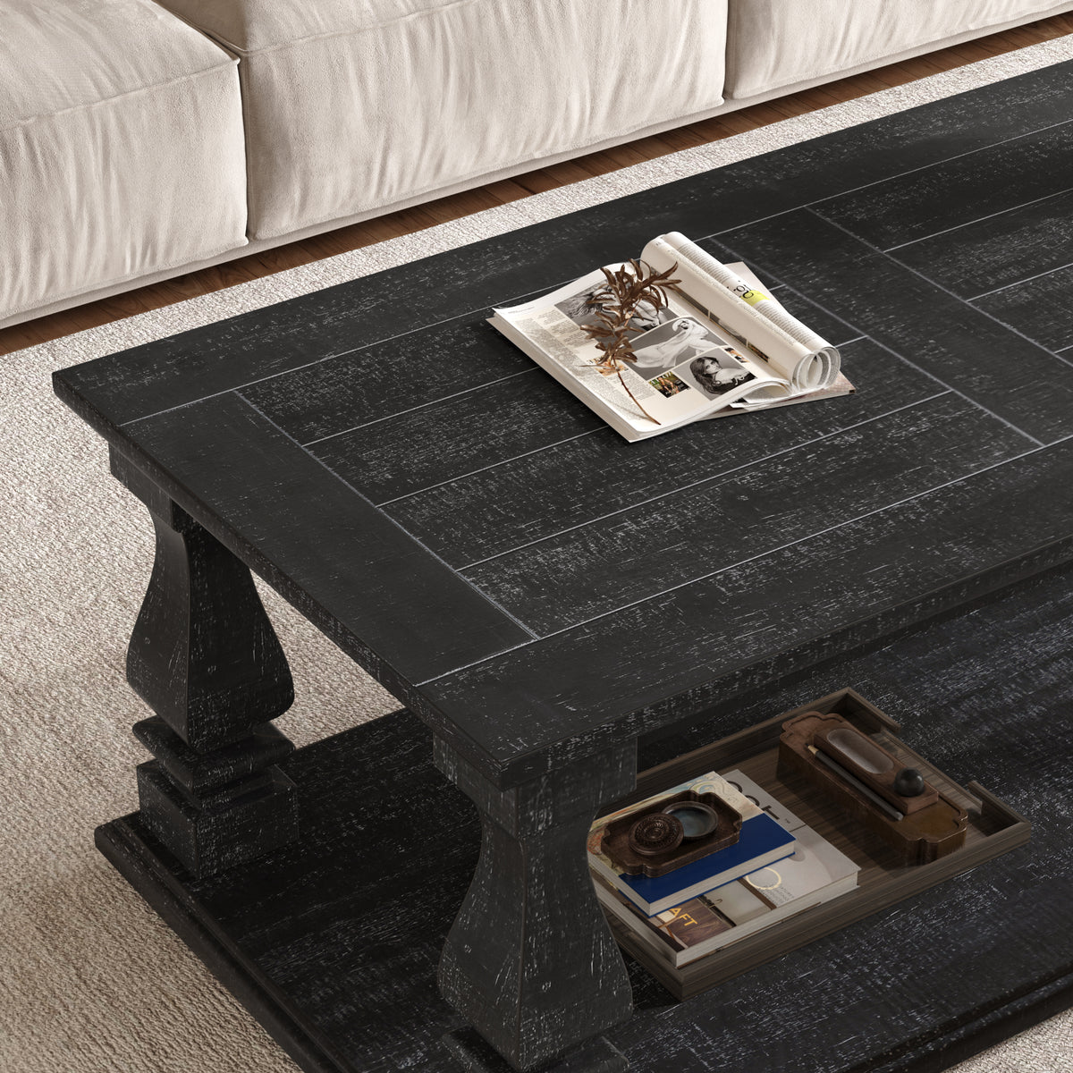 Weathered black farmhouse coffee table by Anthony & Home with heavy plank top, baluster legs, and storage shelf in a rustic style.