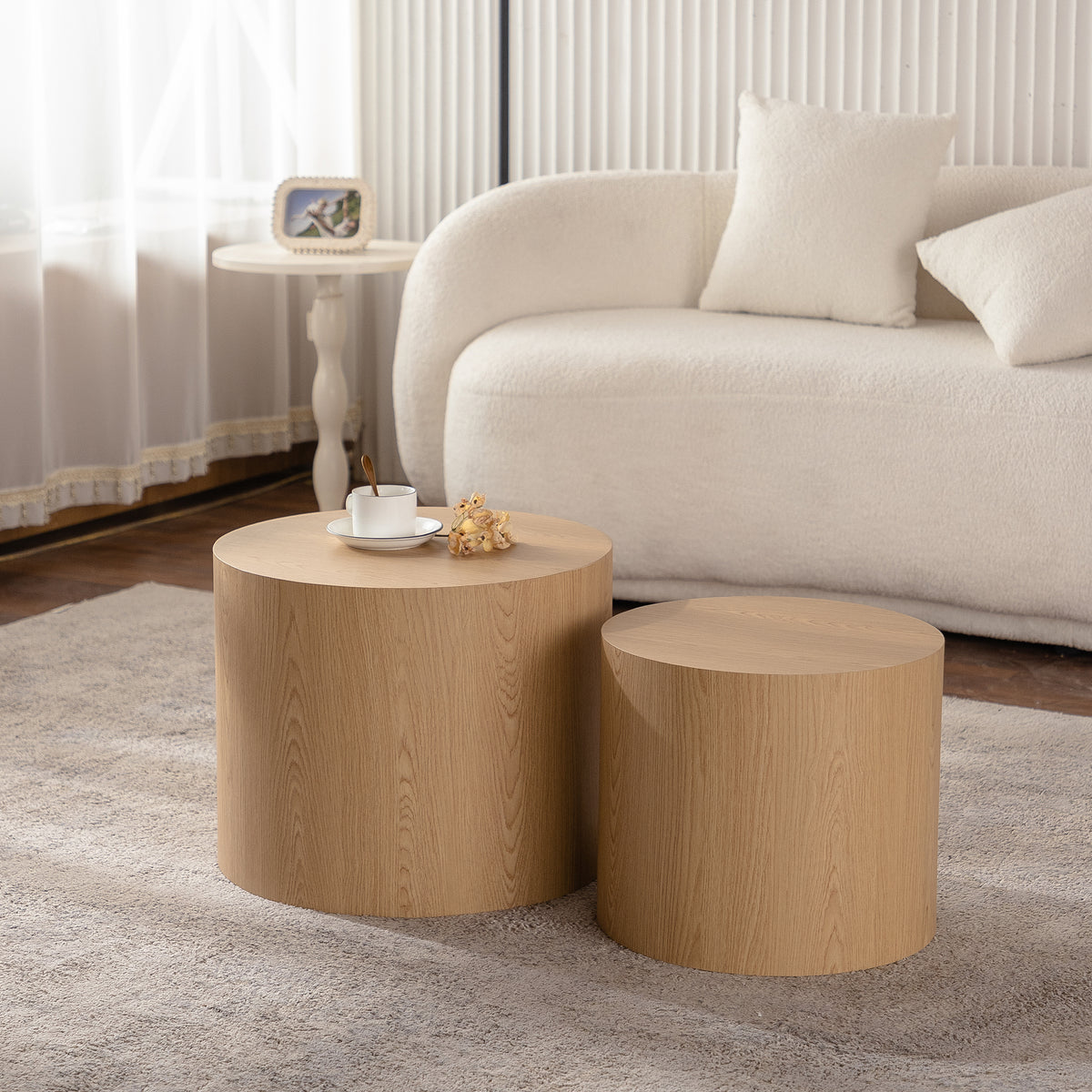Set of nesting round coffee tables by Anthony & Home featuring sleek wooden tops and modern design.