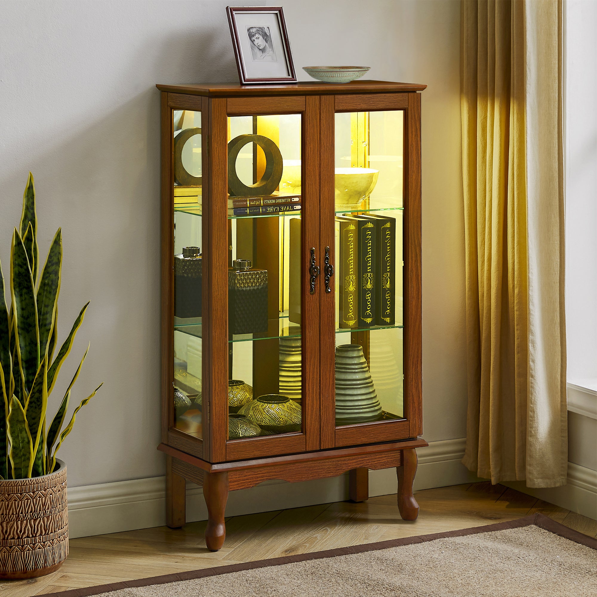 Oak finish lighted curio cabinet with mirrored back by Anthony & Home, showcasing glass shelves and elegant display space.