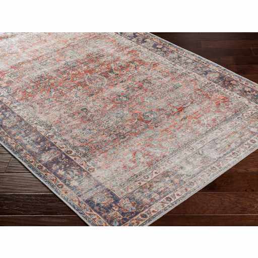 Rustic Anahawan Heritage Elite washable area rug by Hauteloom, shown in corner view with distressed rust tones and textured design.
