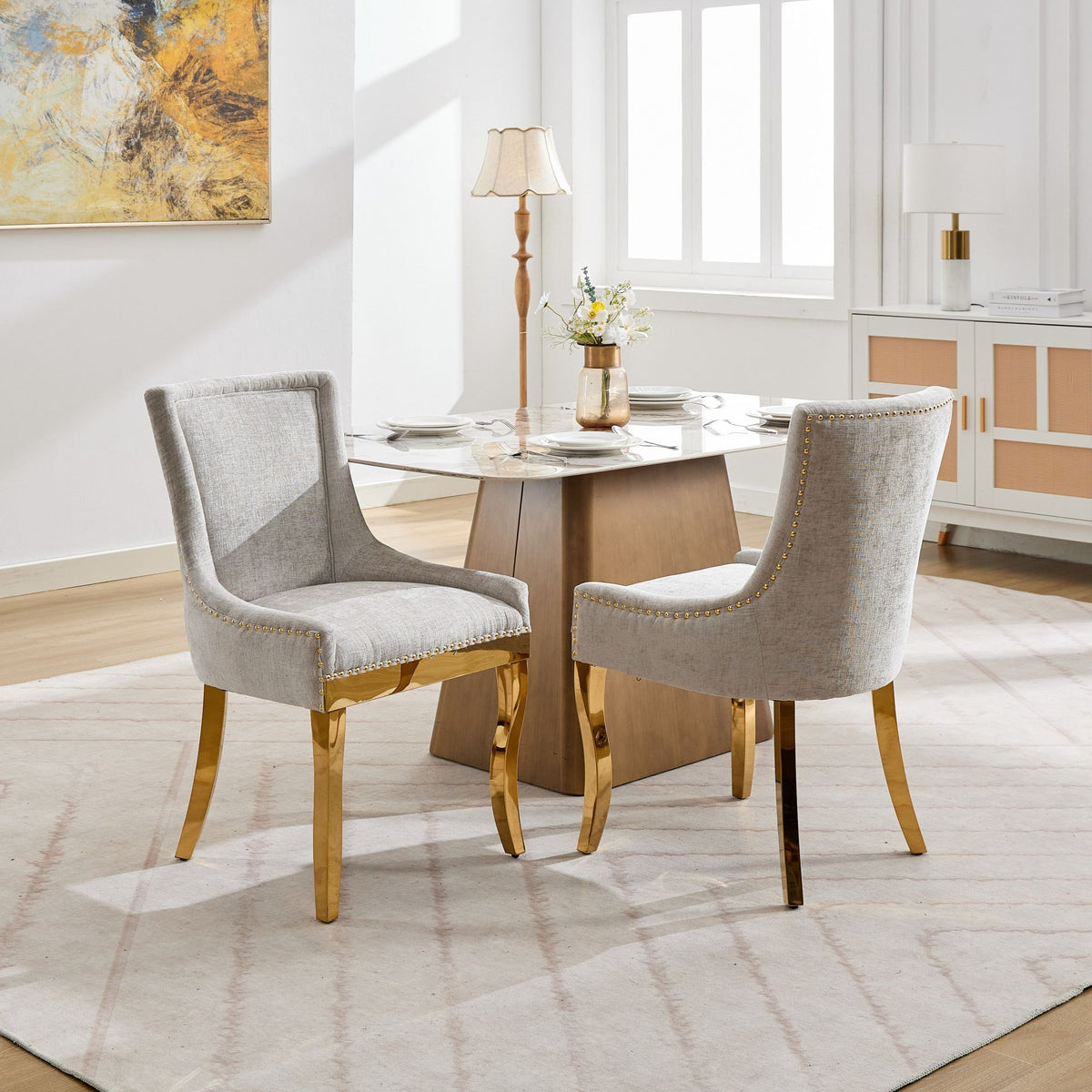 Beige chenille dining chairs with gold-plated legs from Anthony & Home, showcasing a stylish and comfortable seating design.