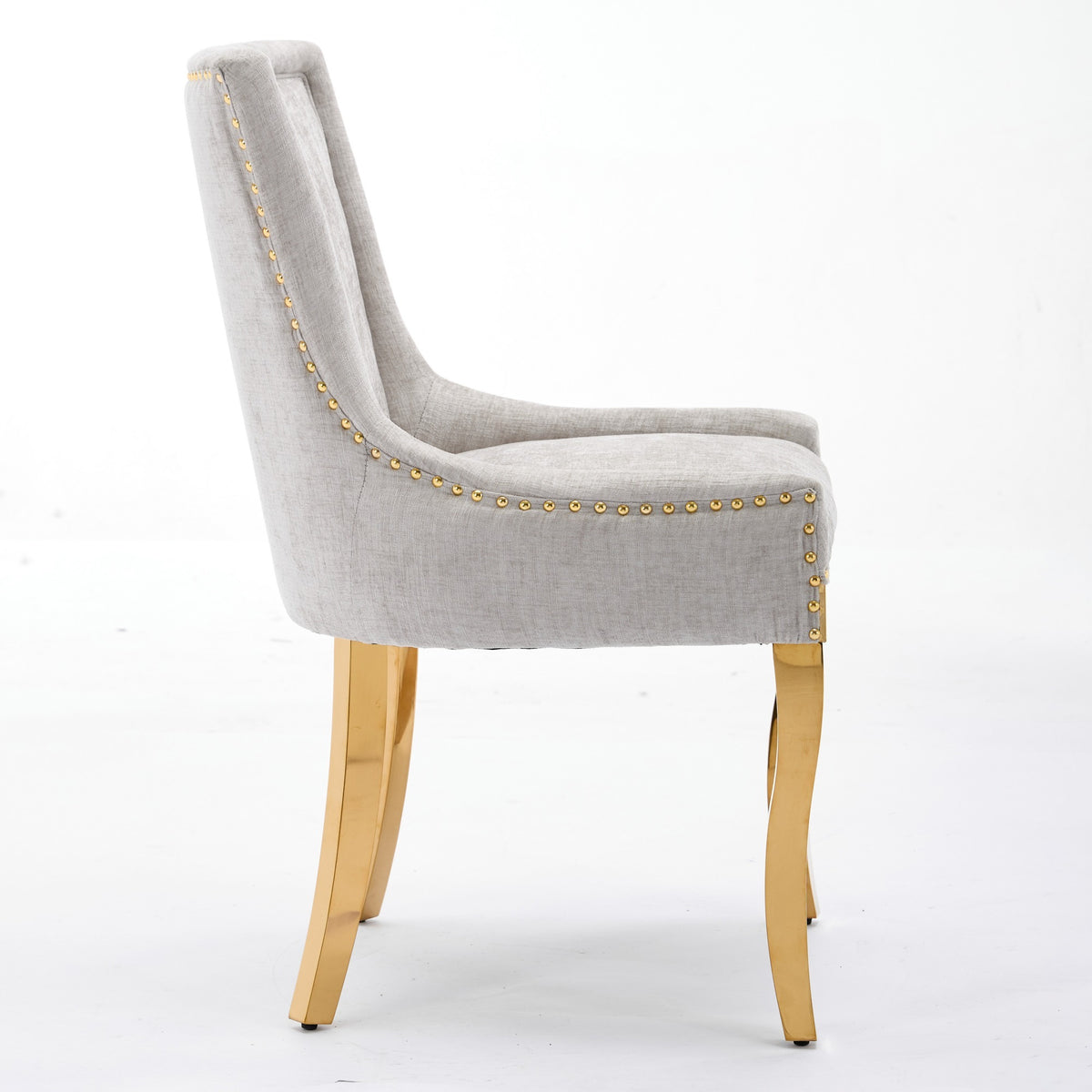 Beige chenille dining chairs with gold plated legs from Anthony & Home, showcasing a modern and elegant studio setting.