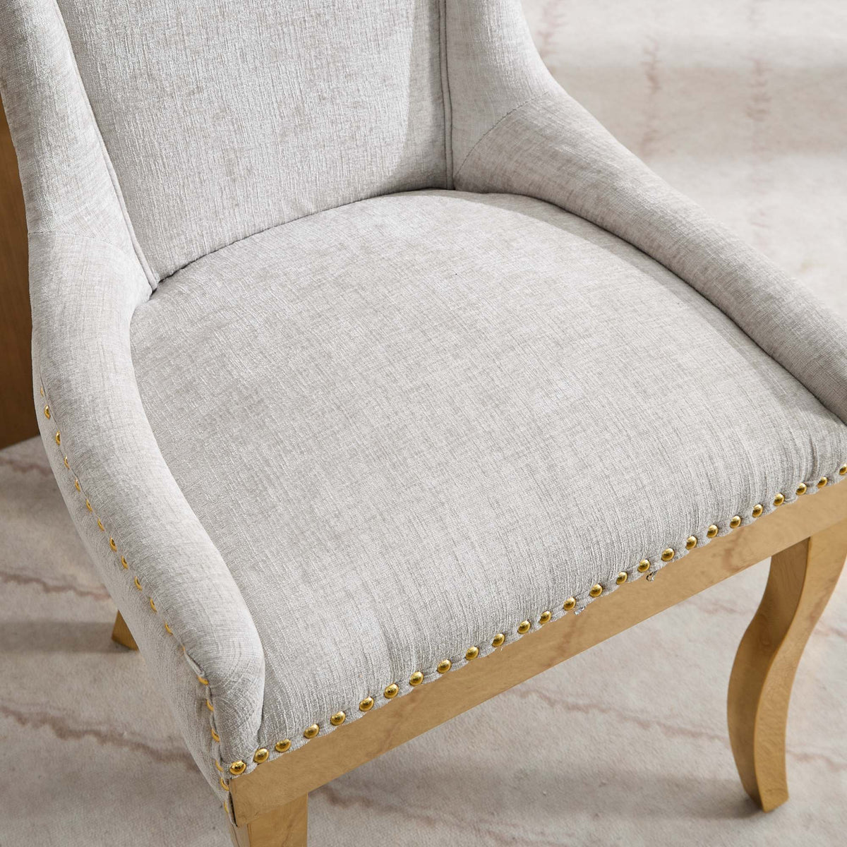 Beige chenille dining chairs with gold plated legs from Anthony & Home, showcasing elegant upholstery and modern design.