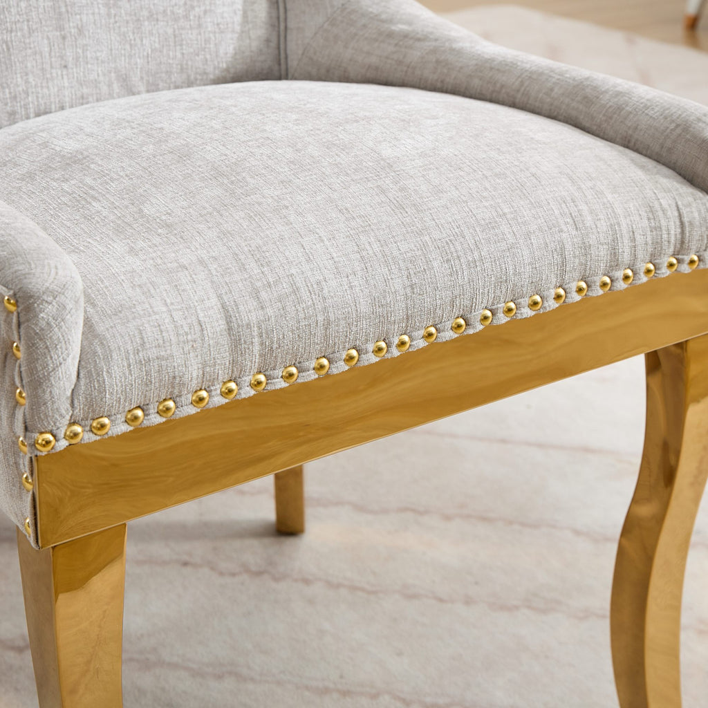 Beige chenille dining chairs with gold plated legs from Anthony & Home, showcasing plush upholstery and elegant metal accents.
