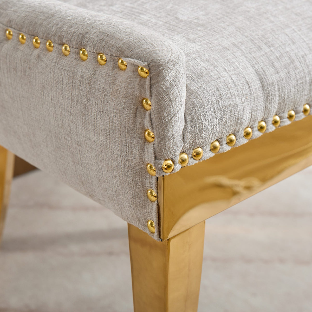 Beige chenille dining chairs with gold plated legs, stylish Anthony & Home studio furniture for modern dining rooms.