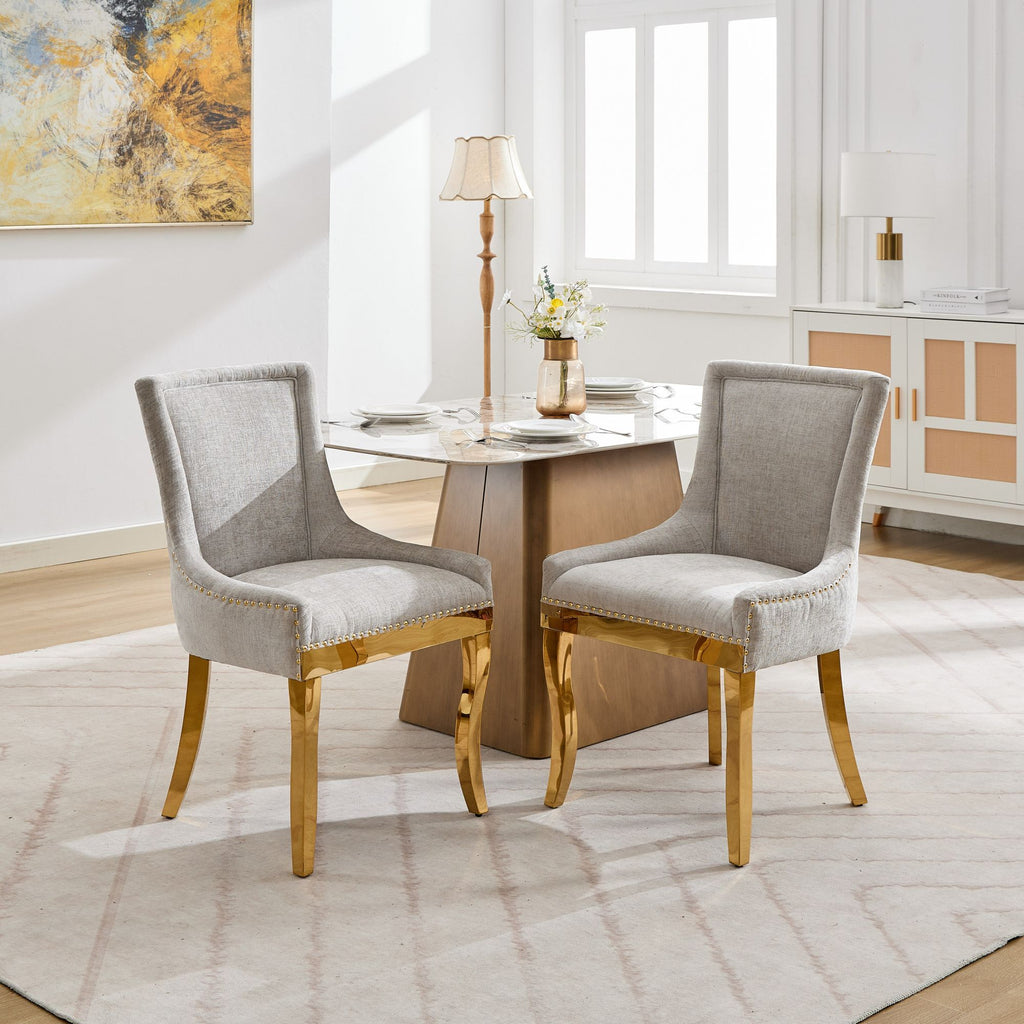 Beige chenille dining chairs with gold plated legs from Anthony & Home, showcasing plush upholstery and elegant design.