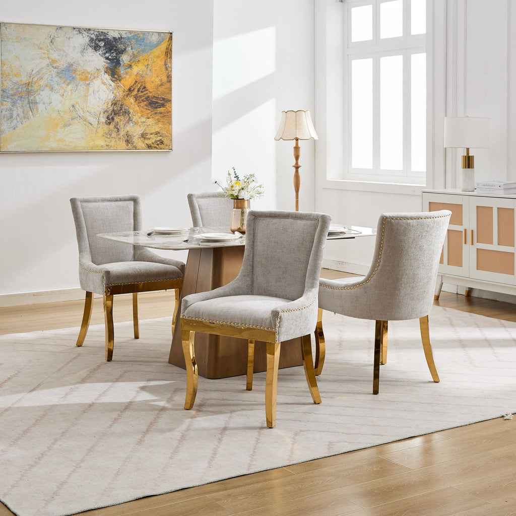 Beige chenille dining chairs with gold-plated legs from Anthony & Home, showcasing plush upholstery and elegant gold accents.