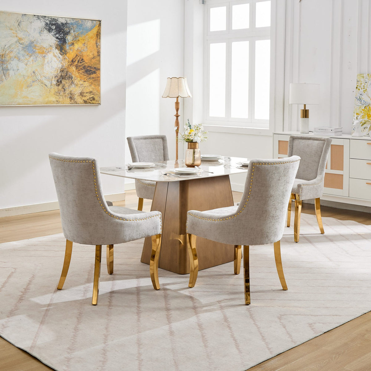 Beige chenille dining chairs with gold-plated legs from Anthony & Home, featuring a stylish and comfortable studio design.