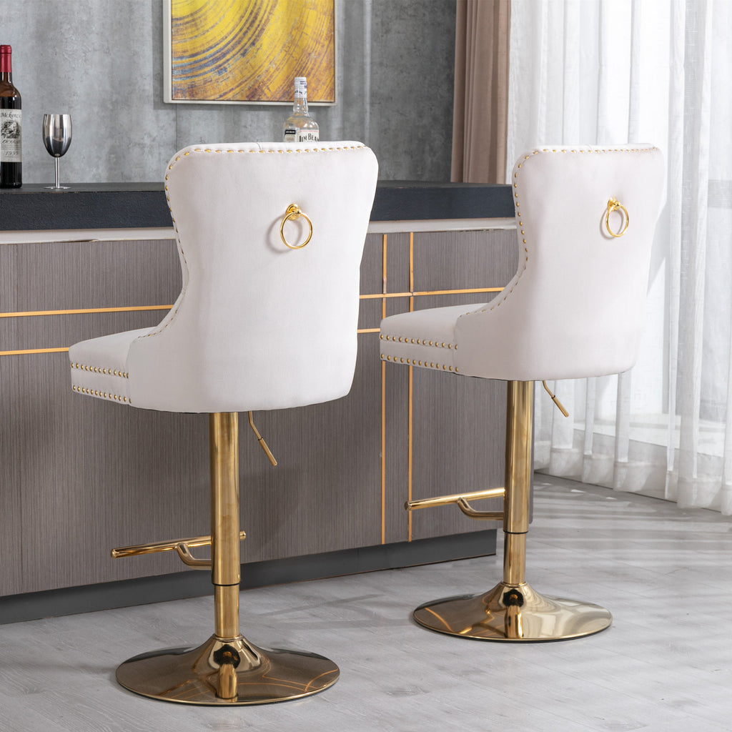 Beige velvet bar stool with tufted seat, copper nailhead trim, and Anthony & Home branding, showcasing elegant design and craftsmanship.