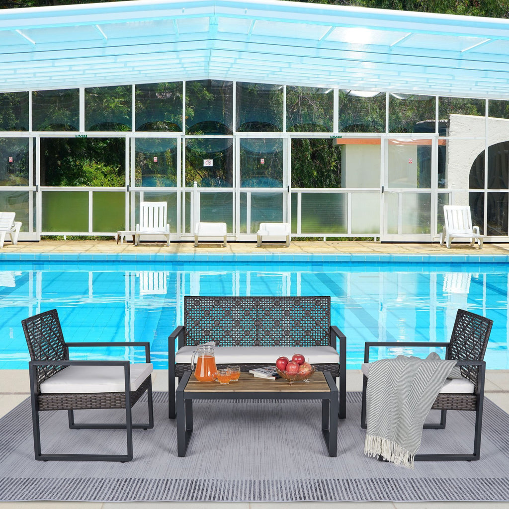 Acacia wood patio table with wicker frame and beige cushions, outdoor Anthony & Home furniture set for garden or patio area.