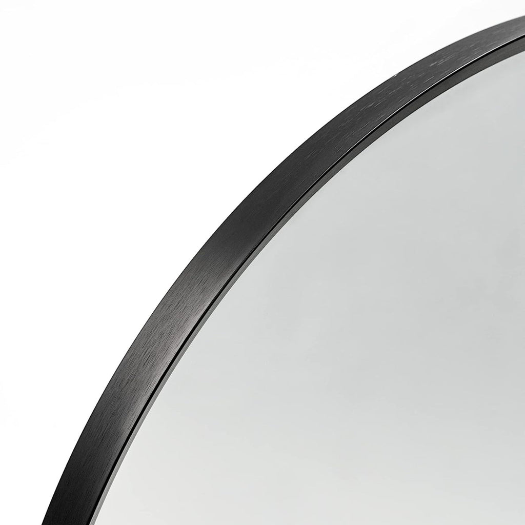 Arched black aluminum bathroom mirror with sleek frame, modern design, and reflective glass, by Anthony & Home.