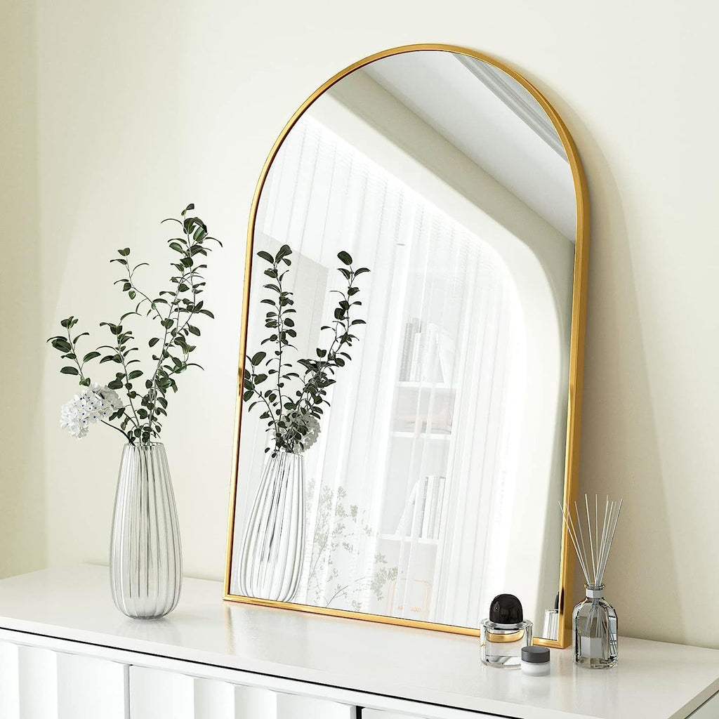 Arched gold metal mirror from Anthony & Home's Classic Collection, featuring a sleek, elegant design with a curved frame.