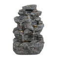 Anthony & Home Atelier faux stone outdoor fountain with five-tier cascading water feature and LED illumination, set in a garden scene.