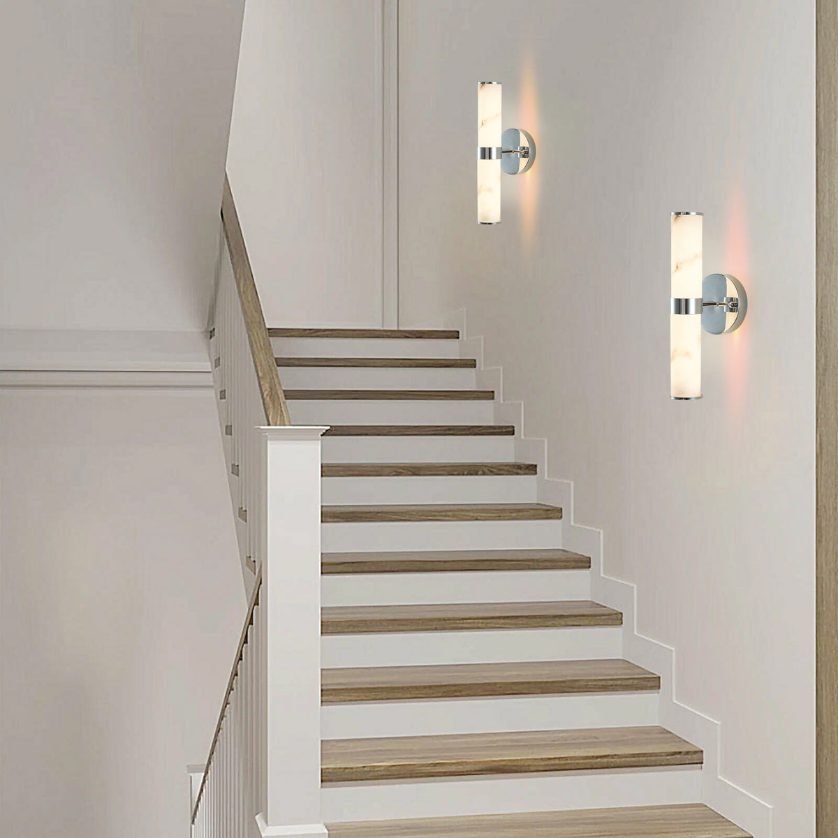 Set of two Anthony & Home Atelier marble wall sconces with sleek modern design, featuring white marble finishes and metal mounting plates.