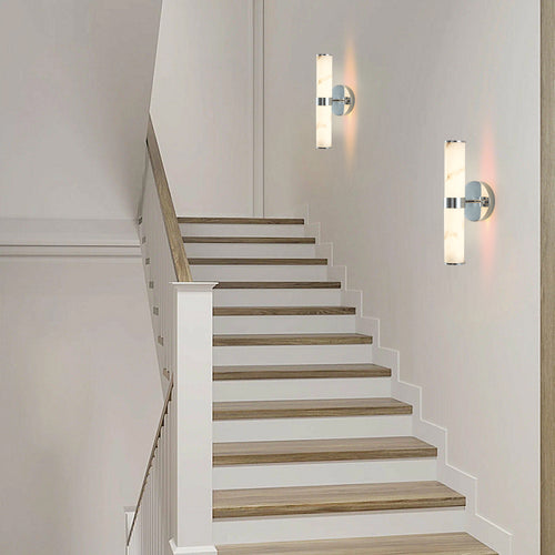 Set of two Anthony & Home Atelier marble wall sconces with modern design and sleek marble finish, mounted on a wall.