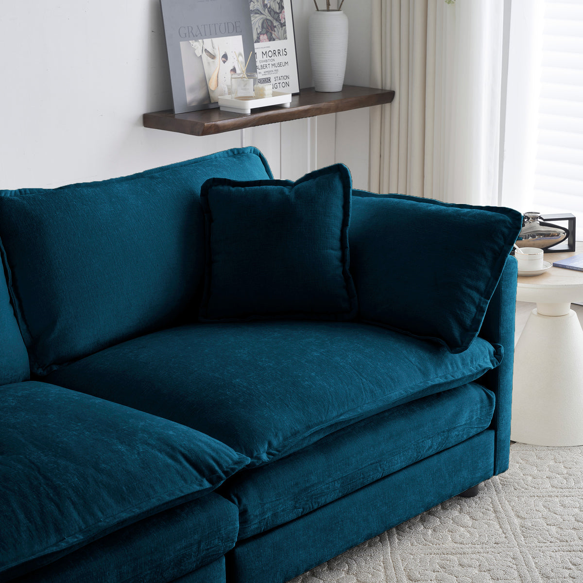 Blue chenille modular L-shaped sofa with reversible ottoman by Anthony & Home, shown in a modern living room setting.