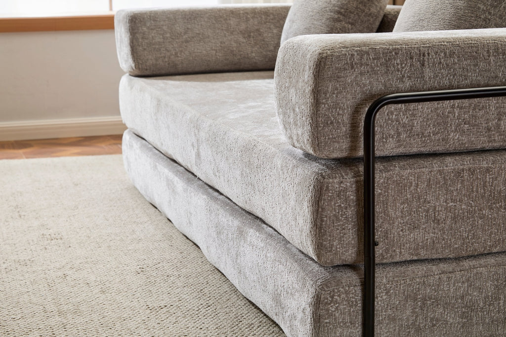 Light grey Anthony & Home chenille floor sofa bed with pillow back in convertible design, Signature Edition, shown in living room setting.