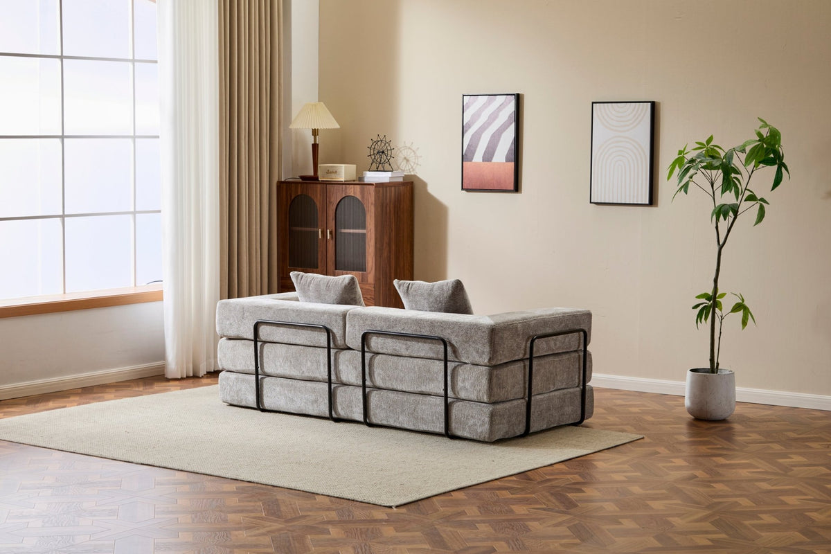 Light grey Anthony & Home chenille sofa bed with pillow back, convertible for lounging or sleeping, Signature Edition style.