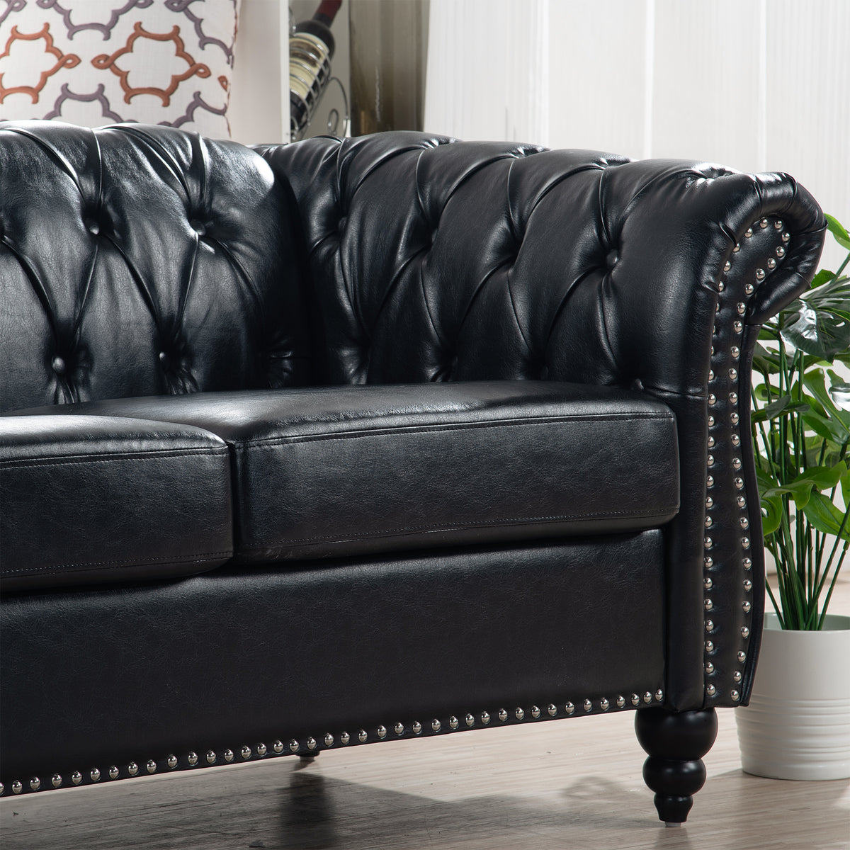Anthony & Home Chesterfield rolled-arm three-seater sofa with plush upholstery and classic design, shown in a cozy living room setting.
