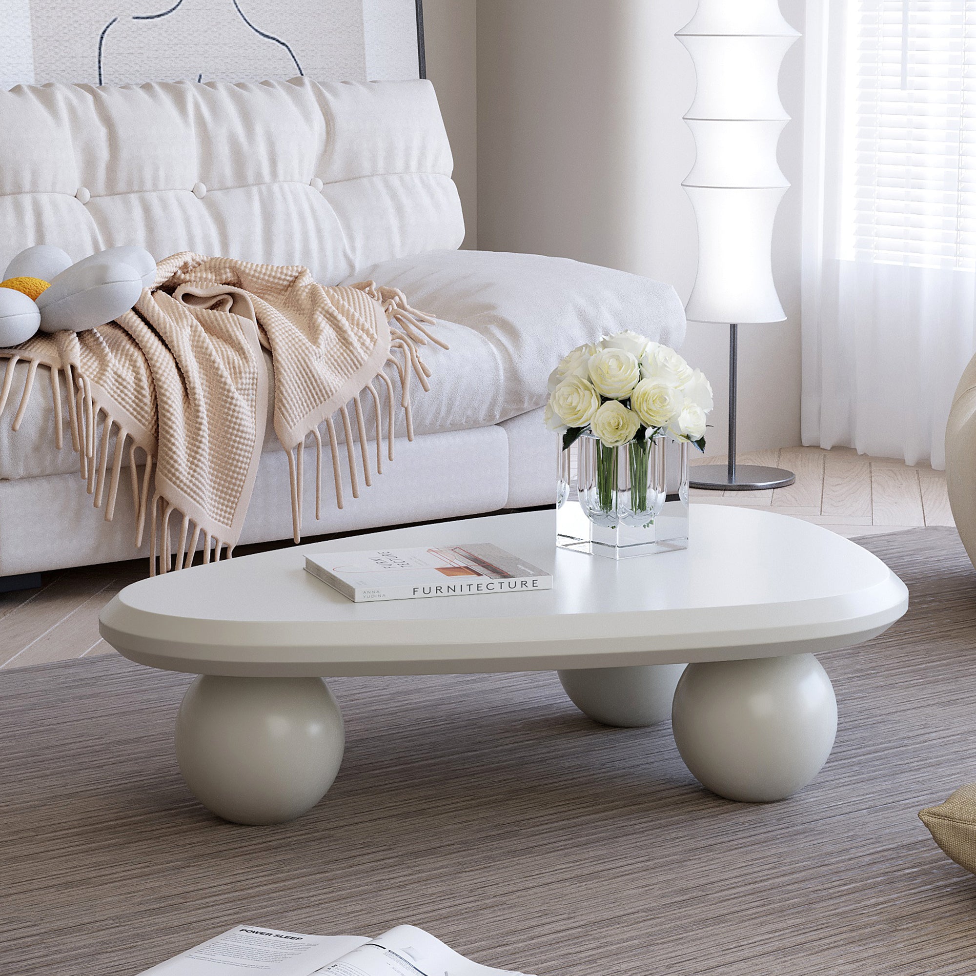 Creamy white lacquered MDF cloud-shaped coffee table with studio teardrop top and three ball metal legs by Anthony & Home.