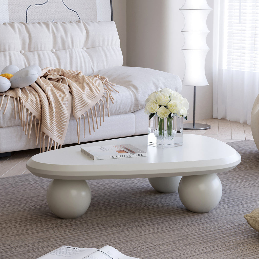 Creamy white lacquered MDF cloud-shaped coffee table with studio teardrop top and three ball metal legs by Anthony & Home.