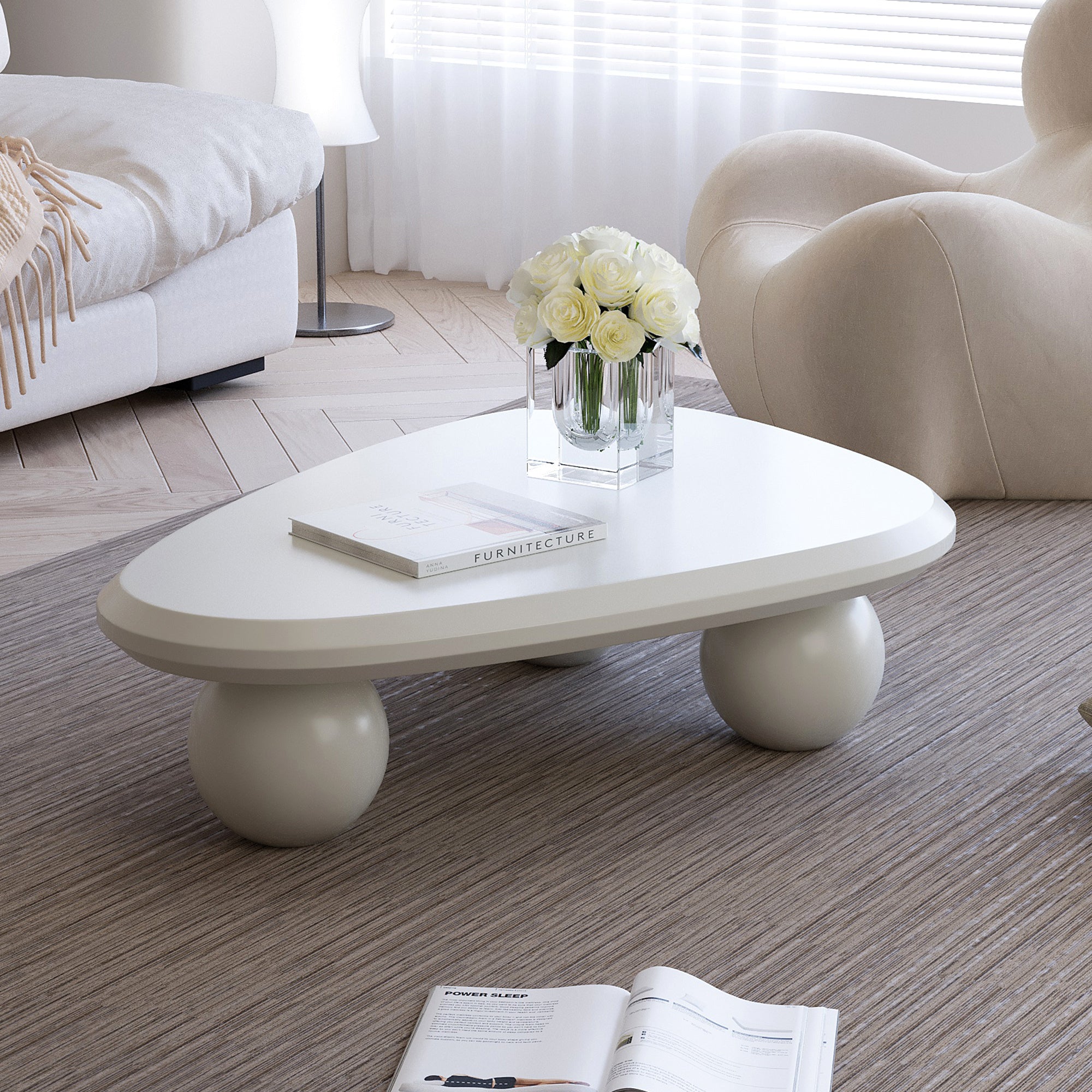 Creamy white lacquered MDF Cloud coffee table with studio teardrop top and three ball legs by Anthony & Home.
