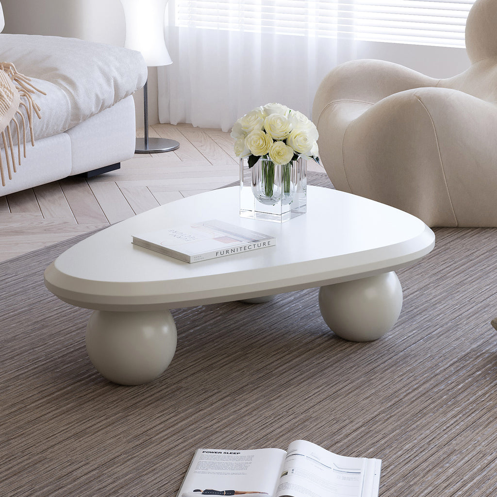 Creamy white lacquered MDF Cloud coffee table with studio teardrop top and three ball legs by Anthony & Home.