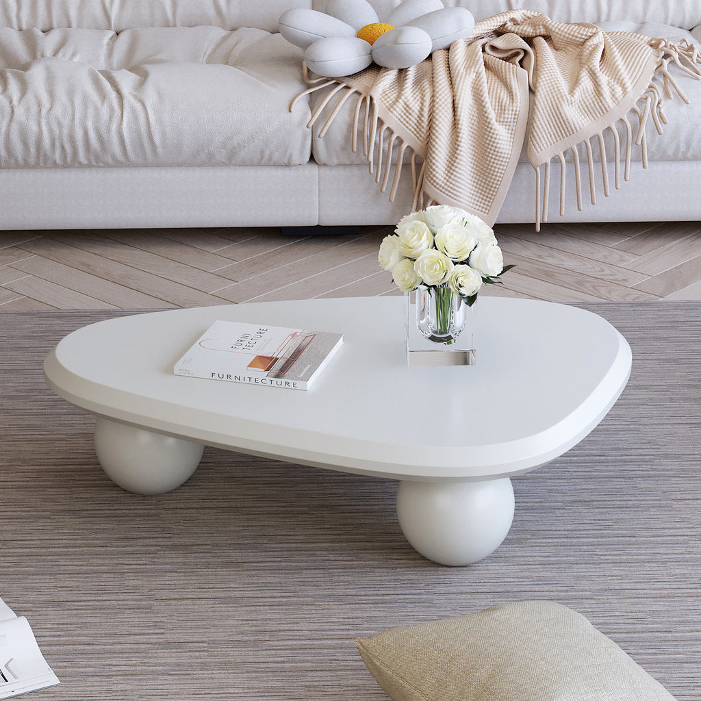 Creamy white lacquered MDF cloud-shaped coffee table with studio teardrop top and three ball legs by Anthony & Home.