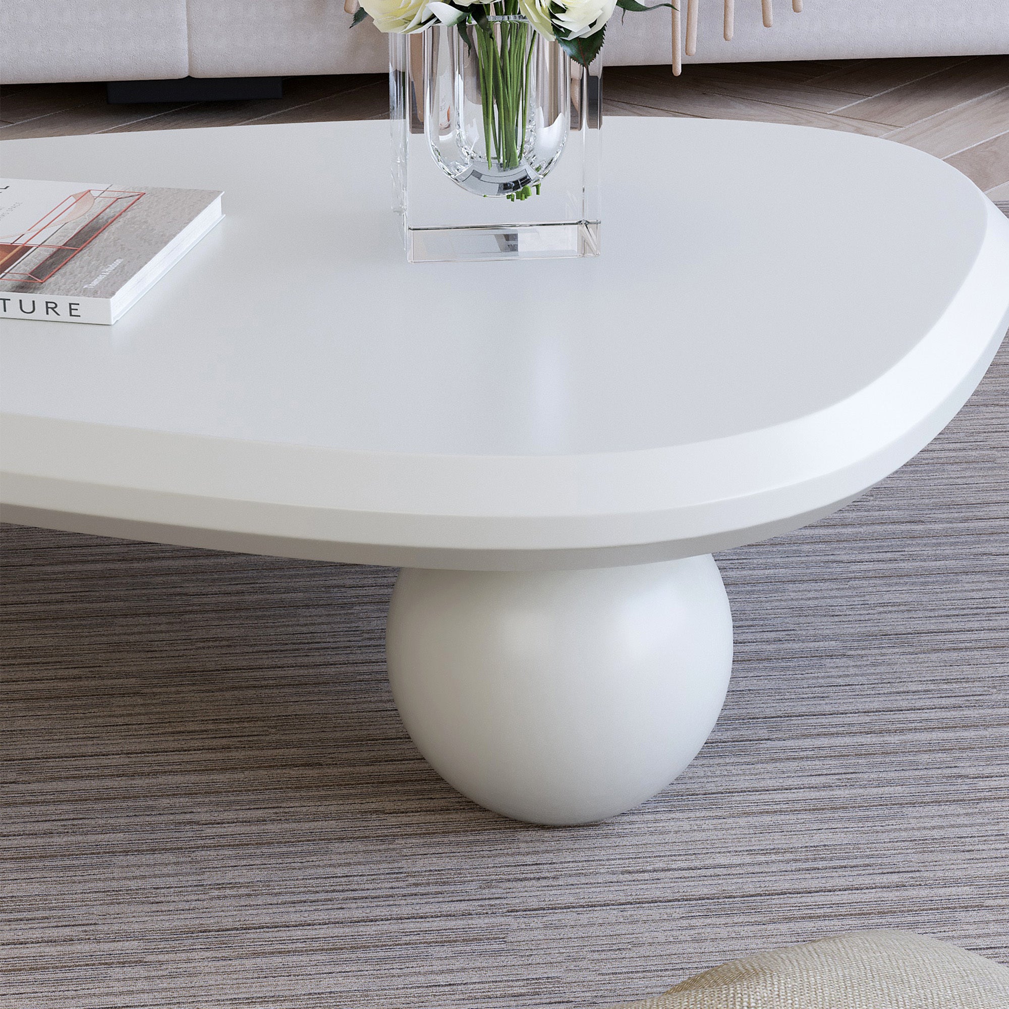 Creamy white lacquered MDF coffee table with studio teardrop top and three ball legs by Anthony & Home.