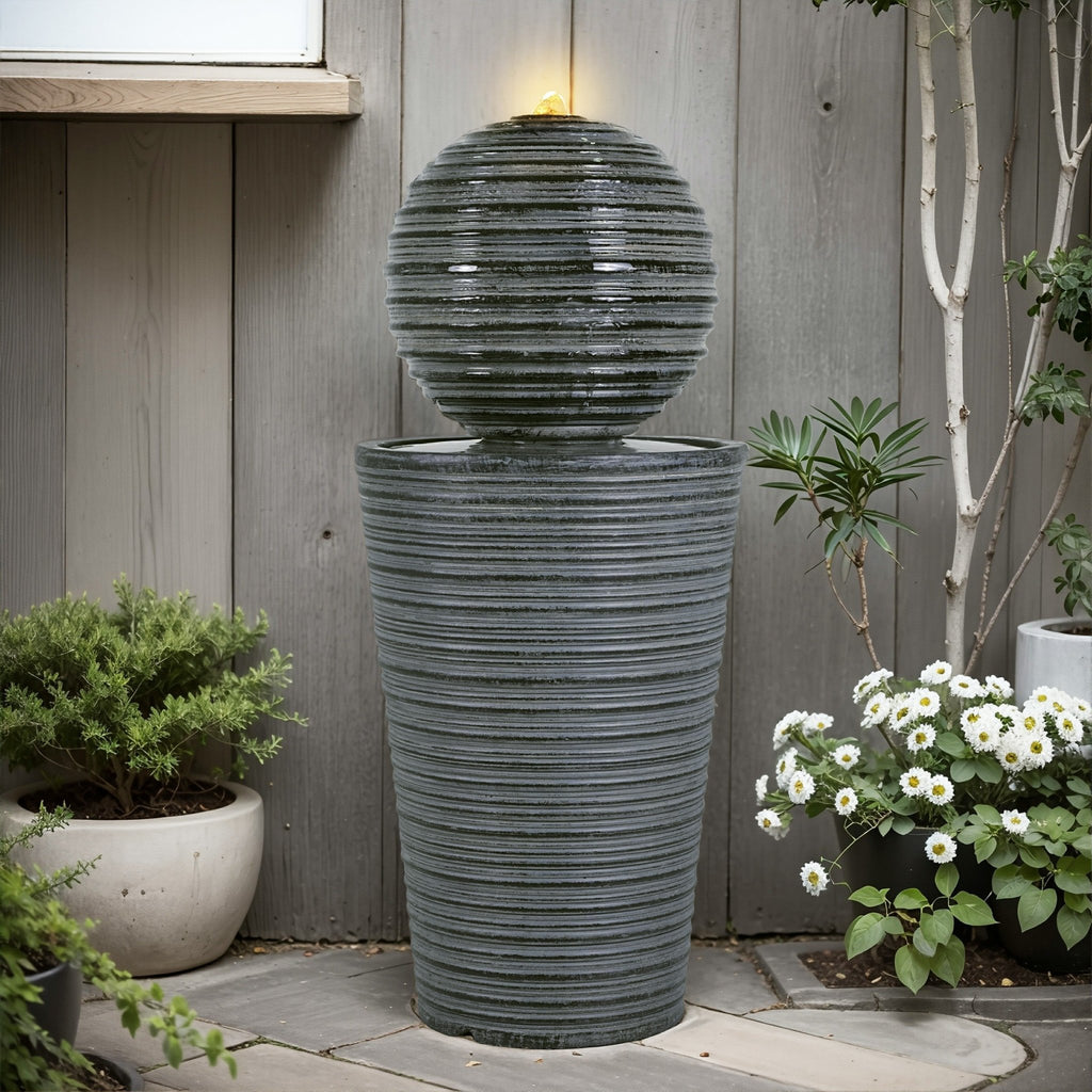 Gray concrete column fountain with striped finish, outdoor decor by Anthony & Home, showcasing a limited edition garden feature.