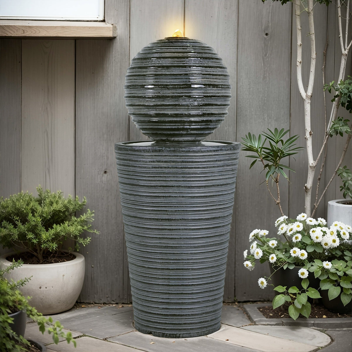 Gray concrete column fountain with striped finish, outdoor decor by Anthony & Home, showcasing a limited edition garden feature.
