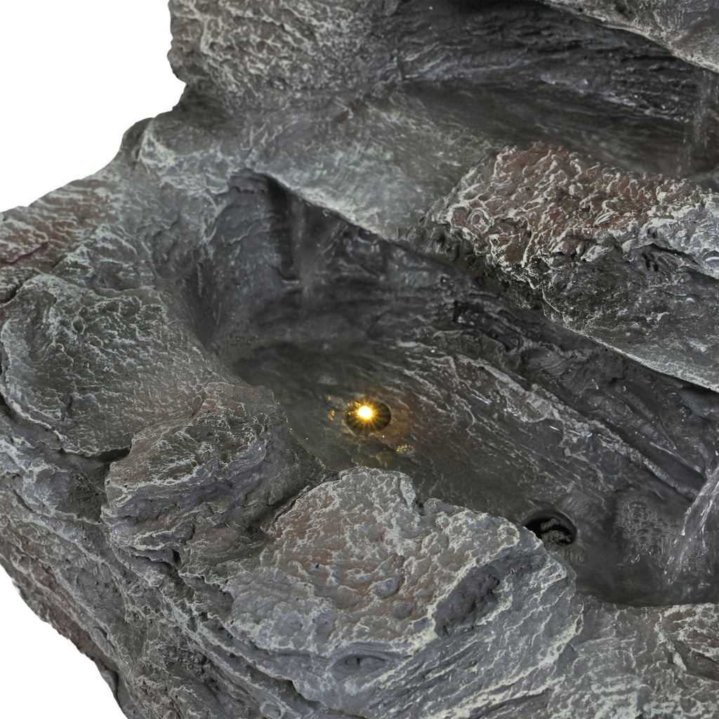 Concrete rock waterfall fountain with a 4-tier design by Anthony & Home, featuring natural stone textures and flowing water.