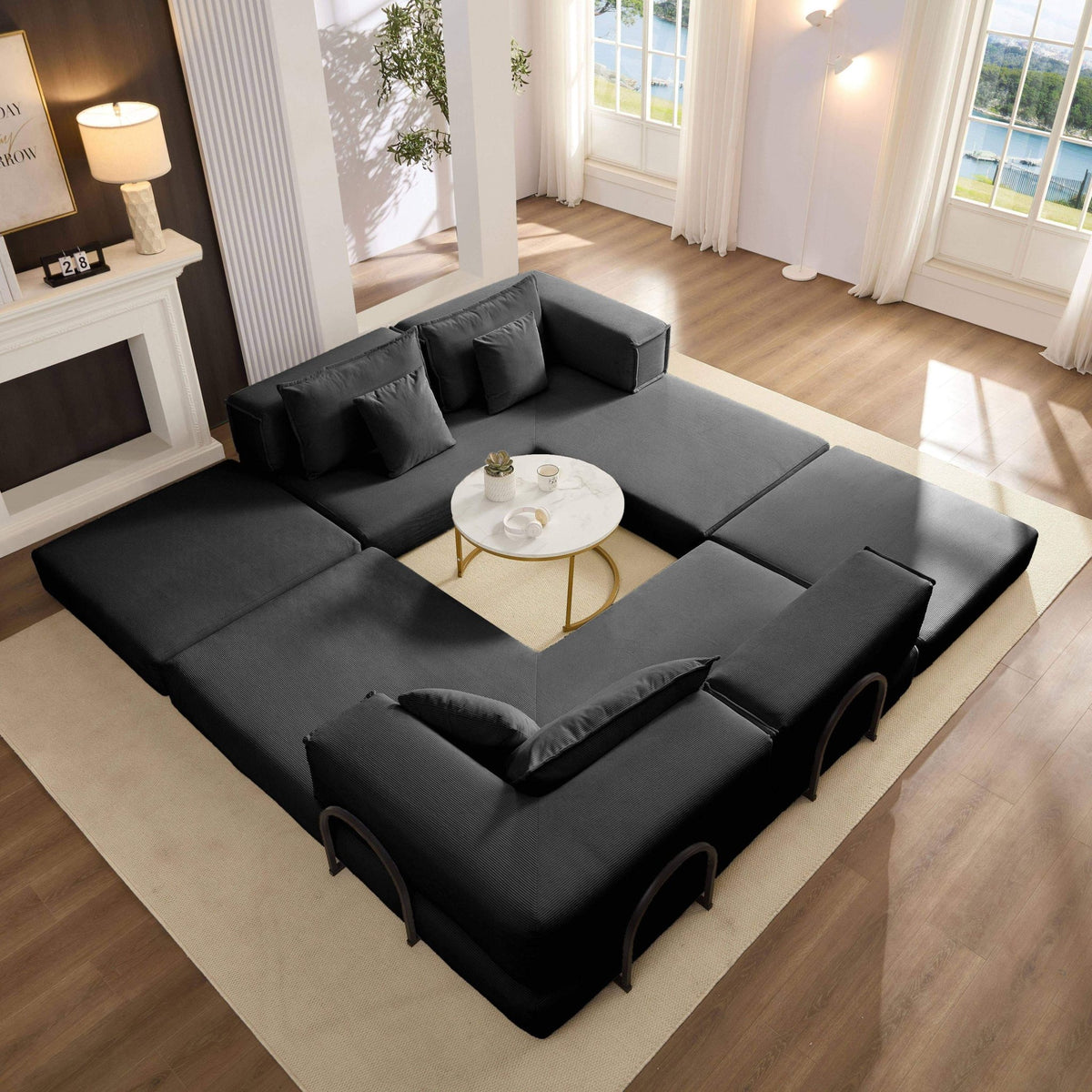 Black corduroy modular sectional sofa by Anthony & Home, showing its plush fabric and customizable sections.