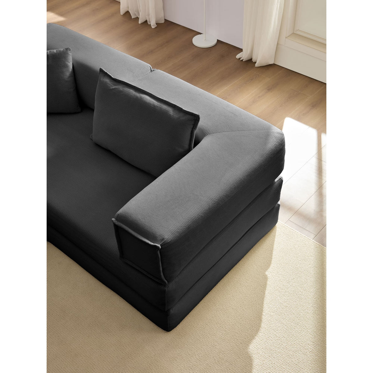Black corduroy modular sectional sofa by Anthony & Home, showcasing comfortable cushions and modern design.