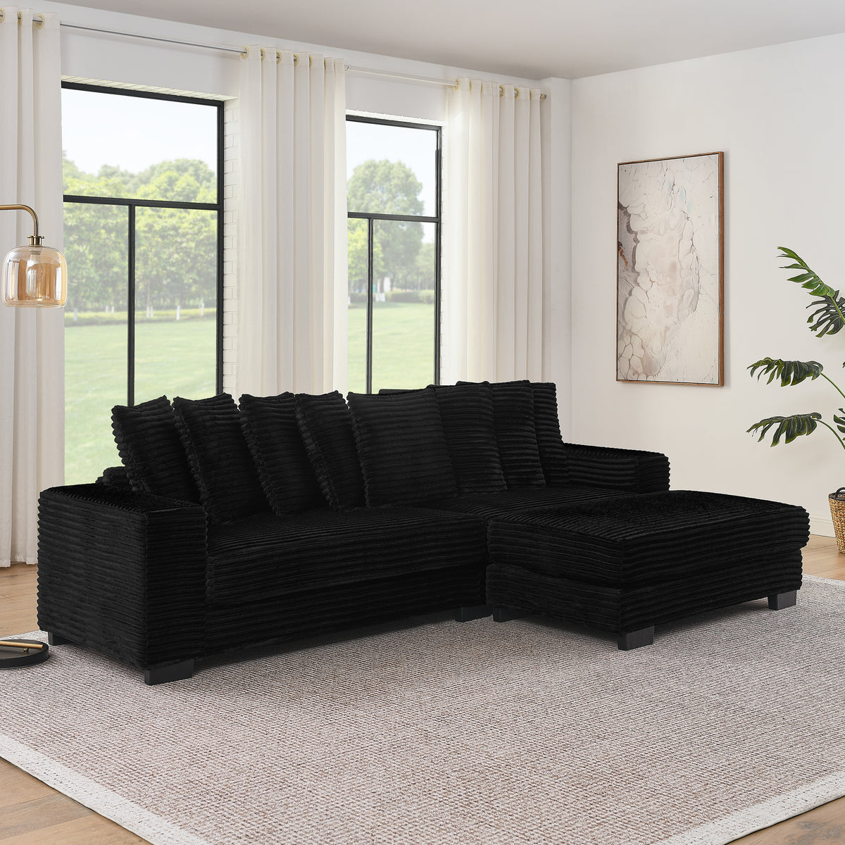 Corduroy tufted sleeper sectional by Anthony & Home featuring plush cushions and a modern design in a neutral color.