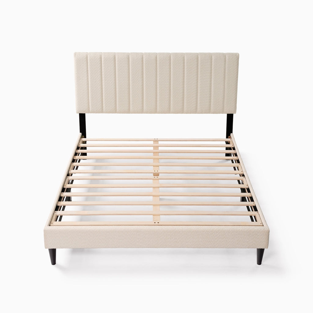 Cream boucle queen platform bed with tufted headboard and midcentury design by Anthony & Home.