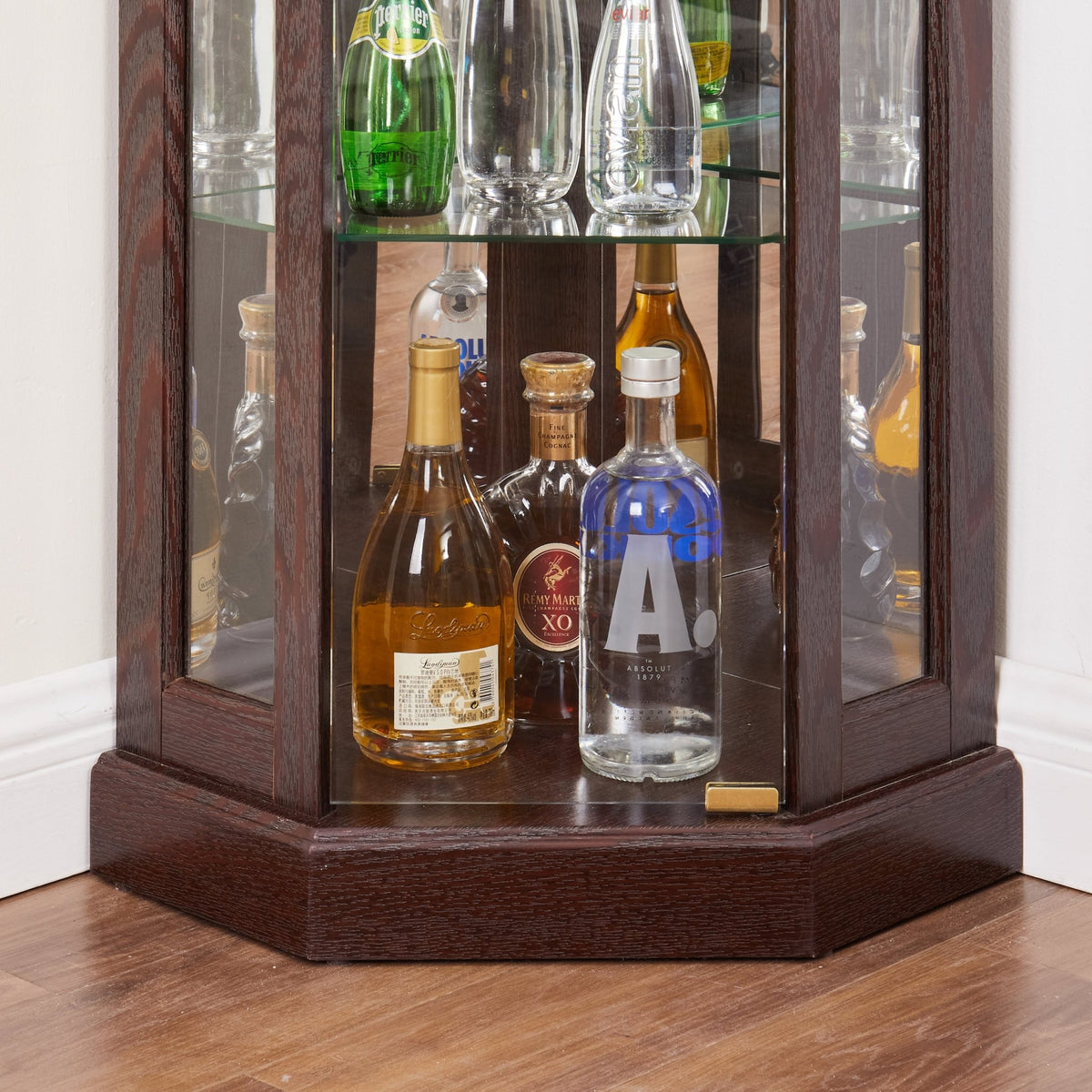 Dark cherry corner curio cabinet by Anthony & Home with glass doors and shelves for displaying collectibles.