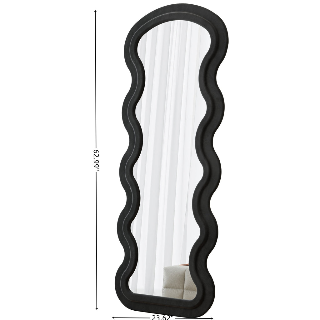 Black Flannel Wave Floor Mirror from Anthony & Home Studio Edition, showcasing a modern, curved design reflected in the image.