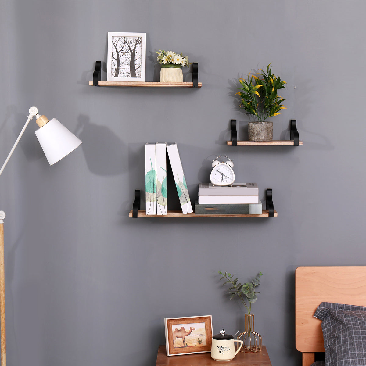 Natural wood floating shelves trio from Anthony & Home, shown mounted on a wall for stylish storage and display.