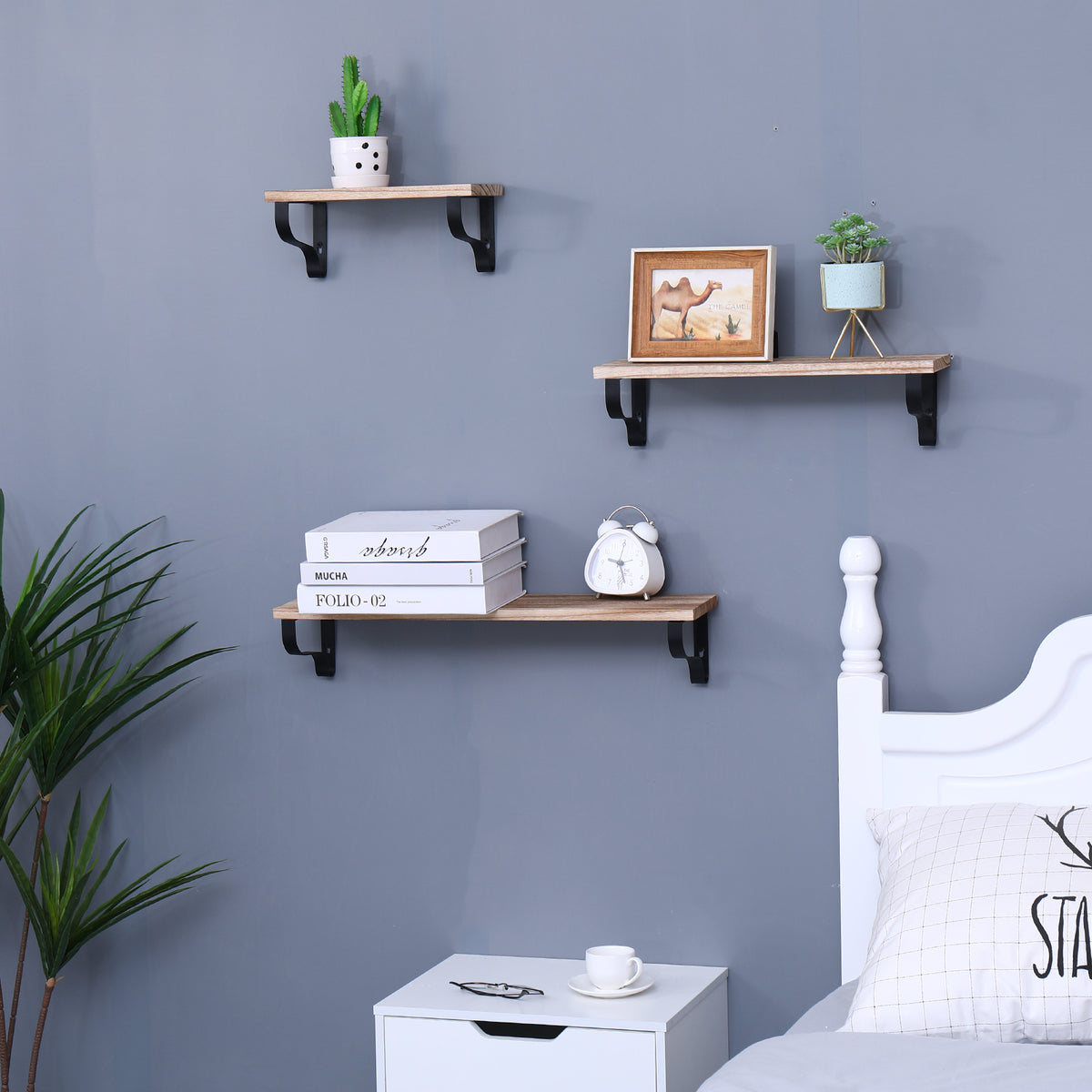 Natural wood floating shelves trio by Anthony & Home mounted on a wall, showcasing stylish modern storage and decor.